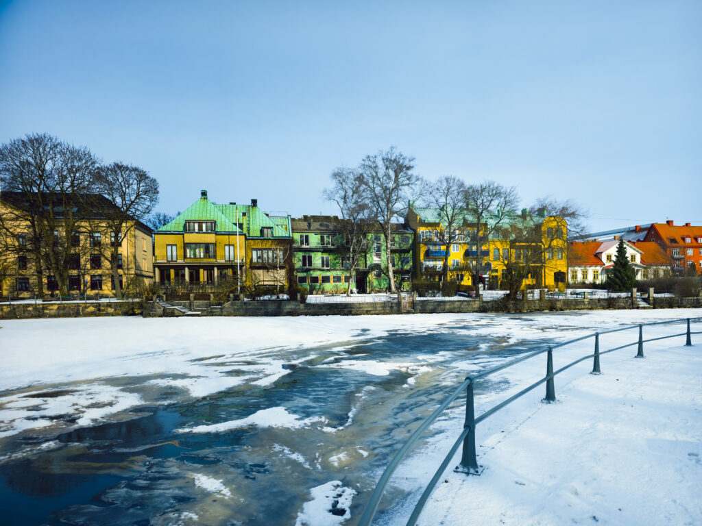 Kolorowe kamienice nad zamarzniętą rzeką Svartån w Örebro w Szwecji