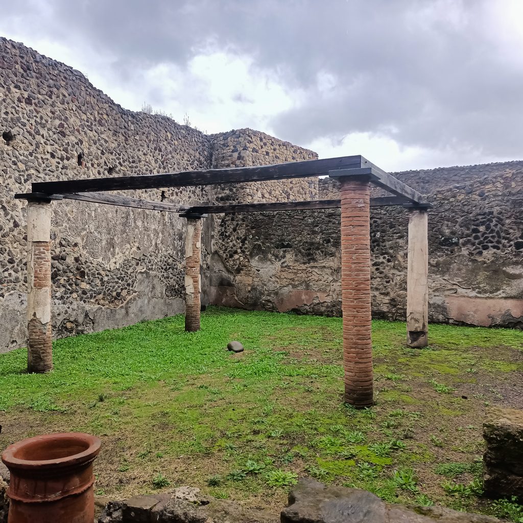 Pozostałości kolumnady i ogrodu w jednym z domów w starożytnych Pompejach