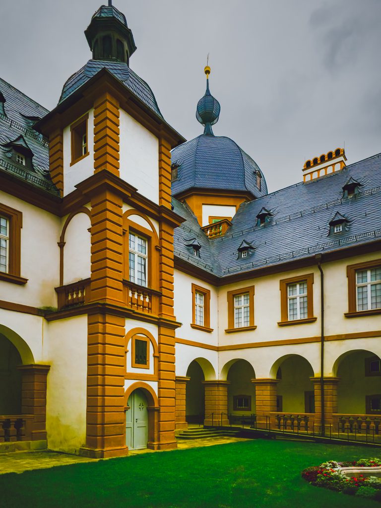 Wewnętrzny dziedziniec pałacu Seehof w Memmelsdorfie z arkadami, narożną wieżą i charakterystycznymi barokowymi kopułami